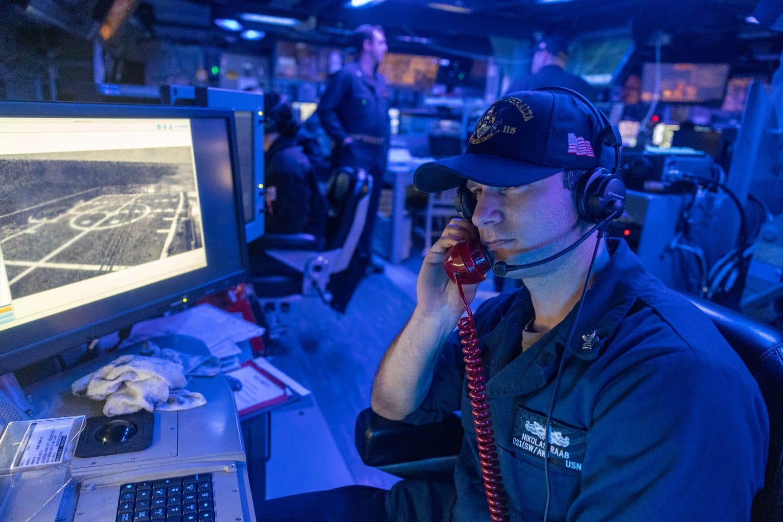 U.S. Navy operations specialist standing watch in the combat information center aboard USS Rafael Peralta (DDG 115)